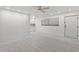 Spacious living room with dining nook featuring tiled floors and bright lighting at 209 Ne Lincoln N Cir # 105, St Petersburg, FL 33702