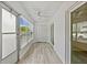 Bright sun room with wood-style flooring, offering a versatile space with natural light at 209 Ne Lincoln N Cir # 105, St Petersburg, FL 33702