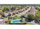 An aerial shot features a community pool, surrounded by residential properties and lush greenery at 23901 Coral Ridge Ln, Land O Lakes, FL 34639