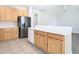Kitchen with breakfast bar, stainless steel refrigerator, and light wood cabinets at 23901 Coral Ridge Ln, Land O Lakes, FL 34639