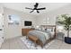 Inviting bedroom featuring a ceiling fan, a mounted television and plenty of natural light at 2401 E Cayuga St, Tampa, FL 33610