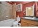 Bathroom with a shower-tub combo and vanity with dark granite countertop at 2537 Gloriosa Dr # 2, Palm Harbor, FL 34684