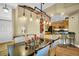 Bright dining area featuring a modern light fixture and glimpses of the kitchen and entry way at 2537 Gloriosa Dr # 2, Palm Harbor, FL 34684