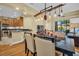 Open-concept dining and living area with wooden floors, modern lighting fixtures, and stainless steel kitchen appliances at 2537 Gloriosa Dr # 2, Palm Harbor, FL 34684