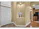 Bright entryway showcasing tile floors, white front door, niche with decorative art, and glimpses of the kitchen at 2537 Gloriosa Dr # 2, Palm Harbor, FL 34684