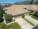 Exterior aerial view of townhome with dual garage, well-maintained landscaping, and lush green lawns at 2537 Gloriosa Dr # 2, Palm Harbor, FL 34684