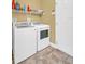 Clean laundry room with white washer and dryer and practical shelving for storage at 2537 Gloriosa Dr # 2, Palm Harbor, FL 34684