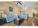 Cozy living area featuring hardwood floors, comfortable couches, and an open floor plan connecting to the dining area at 2537 Gloriosa Dr # 2, Palm Harbor, FL 34684