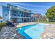 Beautiful backyard showcasing a sparkling pool, a comfortable patio area, and lush landscaping for privacy at 289 8Th N Ave, Tierra Verde, FL 33715