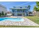 Inviting backyard showcasing a private pool, a patio area with comfortable seating, and a well-maintained lawn at 289 8Th N Ave, Tierra Verde, FL 33715