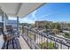 Charming balcony with seating overlooking the neighborhood and a glimpse of the water at 289 8Th N Ave, Tierra Verde, FL 33715