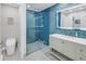 Stylish bathroom with a glass-enclosed shower, modern vanity, and chic blue accent tiles at 289 8Th N Ave, Tierra Verde, FL 33715