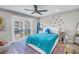 Bright bedroom with a colorful rug, sliding glass door to a balcony, and decorative star accents at 289 8Th N Ave, Tierra Verde, FL 33715