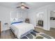 Bright bedroom with a bed and a small bathroom visible, neutral paint, and a window, offering a cozy and inviting space at 289 8Th N Ave, Tierra Verde, FL 33715