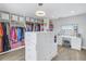 Spacious walk-in closet with custom shelving, drawers, and a vanity area with a lighted mirror, perfect for dressing and organization at 289 8Th N Ave, Tierra Verde, FL 33715
