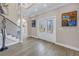 Spacious front foyer with staircase, light wood flooring, and decorative art showcasing the home's stylish design at 289 8Th N Ave, Tierra Verde, FL 33715