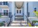 Grand front entrance showcasing a beautiful light fixture, stone stairs, double doors, and wrought-iron balcony railings at 289 8Th N Ave, Tierra Verde, FL 33715