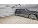 Tiled garage featuring a modern SUV and a convenient automatic door opener for easy access at 289 8Th N Ave, Tierra Verde, FL 33715