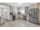 Bright eat-in kitchen featuring stainless steel appliances, stone countertops, and a skylight for lots of natural light at 289 8Th N Ave, Tierra Verde, FL 33715