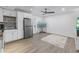 An open living area featuring a stainless steel fridge, white cabinets, and a TV, creating a cozy space at 289 8Th N Ave, Tierra Verde, FL 33715