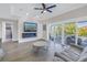 Cozy living room with modern fireplace and large sliding glass doors opening to a scenic outdoor area at 289 8Th N Ave, Tierra Verde, FL 33715