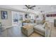 Living room features large sectional couch, ceiling fans and glass doors leading to patio at 289 8Th N Ave, Tierra Verde, FL 33715