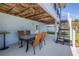 Covered outdoor patio with wooden ceiling and blue walls, featuring a table with four chairs at 289 8Th N Ave, Tierra Verde, FL 33715