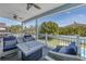 Covered outdoor patio with comfortable seating, ceiling fans, and serene views of the backyard at 289 8Th N Ave, Tierra Verde, FL 33715