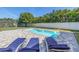 Backyard pool surrounded by brick pavers and tropical landscaping at 289 8Th N Ave, Tierra Verde, FL 33715