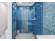 Bathroom with a glass shower featuring blue tile, modern fixtures, and recessed lighting at 289 8Th N Ave, Tierra Verde, FL 33715