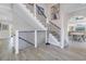 Elegant staircase with sleek metal railings, white risers, and an open layout leading to other parts of the home at 289 8Th N Ave, Tierra Verde, FL 33715