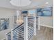 Bright staircase featuring modern chandelier, art, and custom railings at 289 8Th N Ave, Tierra Verde, FL 33715