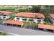 Aerial view showcasing condos with carports, landscaping, and assigned parking at 3500 El Conquistador Pkwy # 242, Bradenton, FL 34210
