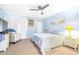 Bedroom with light-blue walls, carpet, and a glass sliding door to a balcony at 3500 El Conquistador Pkwy # 242, Bradenton, FL 34210