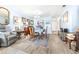 A well lit dining room featuring wood floors, vintage decor, and space for hosting at 3500 El Conquistador Pkwy # 242, Bradenton, FL 34210