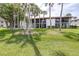 Beautiful two-story home with lush green lawn and several palm trees at 3500 El Conquistador Pkwy # 242, Bradenton, FL 34210