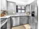 Kitchen featuring stainless steel appliances, mosaic backsplash, and plentiful cabinets at 3500 El Conquistador Pkwy # 242, Bradenton, FL 34210