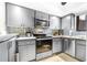 Updated kitchen featuring stainless steel appliances, modern backsplash, and sleek cabinets at 3500 El Conquistador Pkwy # 242, Bradenton, FL 34210