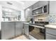 Open kitchen area with stainless steel appliances and breakfast bar with seating at 3500 El Conquistador Pkwy # 242, Bradenton, FL 34210