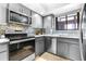 Modern kitchen featuring stainless steel appliances, sleek cabinetry, and mosaic backsplash at 3500 El Conquistador Pkwy # 242, Bradenton, FL 34210