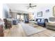 Open living room with glass sliding doors to the deck and comfortable blue couches at 3500 El Conquistador Pkwy # 242, Bradenton, FL 34210