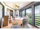 Bright sunroom with tile floors, ceiling fan, and sliding glass doors overlooking lush green landscape at 3500 El Conquistador Pkwy # 242, Bradenton, FL 34210
