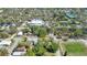 An aerial view of a neighborhood nearby full of houses and trees, plus a church and pond at 3601 N 18Th St, Tampa, FL 33605