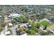 An aerial view of a neighborhood nearby full of houses and trees, plus a church, pond, and sports field at 3601 N 18Th St, Tampa, FL 33605