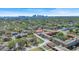 An aerial view of a cityscape far away and a neighborhood nearby full of houses and trees at 3601 N 18Th St, Tampa, FL 33605