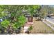Exterior view of a house undergoing renovation with a visible frame and front steps, surrounded by trees at 3601 N 18Th St, Tampa, FL 33605