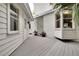 A gray deck connects white-sided buildings; potted plants add charm to the outdoor space at 412 E Marshall St, Safety Harbor, FL 34695