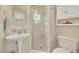 Cozy bathroom with a pedestal sink, frosted glass enclosed shower, and bright natural light at 412 E Marshall St, Safety Harbor, FL 34695