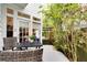 Inviting outdoor patio with table, chairs, and lush tropical plants provides a tranquil retreat at 412 E Marshall St, Safety Harbor, FL 34695