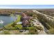 Wide aerial view of Calusa Trace's condos, community pool, and surrounding lake and wooded areas near Veterans Expressway at 4209 Woodstorks Walk Way # 1304, Lutz, FL 33558